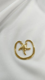 Adorno metalico estrella de mar dorado